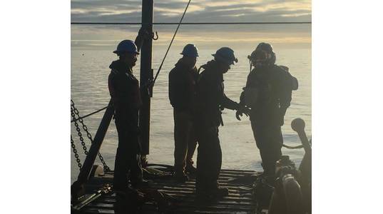 Beginning at dawn, divers begin a series of dives during slack tides to secure the Snap Wrap composite split sleeves to damaged areas of a pipeline in Cook Inlet, Alaska. (Photo courtesy of ClockSpring|NRI)