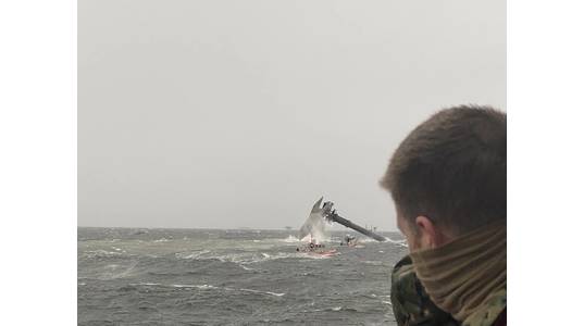 The crew of the Coast Guard Cutter Glenn Harris pulls a person from the water April 13, 2021 after a 175-foot commercial lift boat Seacro Power capsized 8 miles south of Port Fourchon, LA. (U.S. Coast Guard photo courtesy of Coast Guard Cutter Glenn Harris)