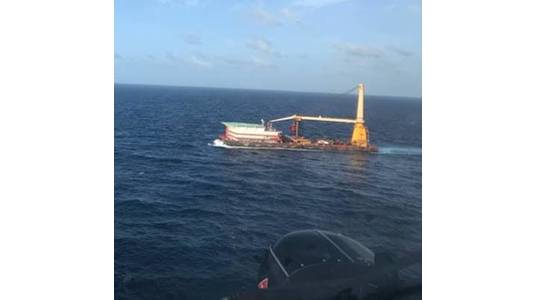 A Coast Guard helicopter crew rendezvous with the 400-foot DB Superior Performance barge June 28 2021, approximately 140 nautical miles south of Ponce, Puerto Rico during the medevac of a barge crewmember who was experiencing possible cardiac distress. (Photo: U.S. Coast Guard)
