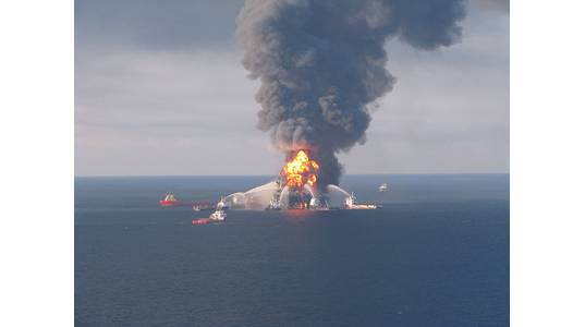 Deepwater Horizon burning in April 2010. Image by US Coast Guard