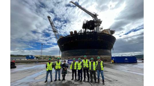 Representatives from DNeX and Ping in front of newly renamed FPSO to Excalibur. Photo from DNeX.