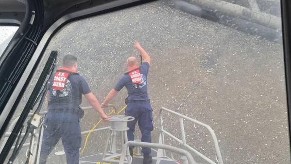 A Coast Guard boat crew attempts to throw a hammer at the hull of the Seacor Power in an attempt to make contact with potential survivors inside the vessel. (U.S. Coast Guard photo courtesy of Coast Guard Station Grand Isle)