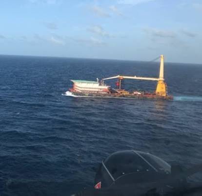 A Coast Guard helicopter crew rendezvous with the 400-foot DB Superior Performance barge June 28 2021, approximately 140 nautical miles south of Ponce, Puerto Rico during the medevac of a barge crewmember who was experiencing possible cardiac distress. (Photo: U.S. Coast Guard)