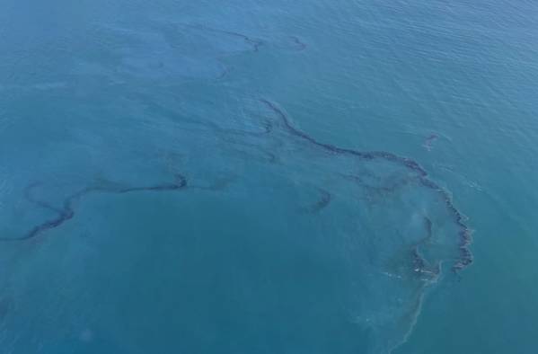 Crude oil is shown in the Pacific Ocean offshore of Orange County, Calif., on October 3, 2021. (Photo: Richard Brahm / U.S. Coast Guard)