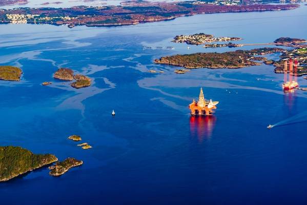 Industrialized nations, such as Norway whose great wealth stems from selling oil and gas, are responsible for most of the excess greenhouse gases accumulated in the atmosphere, while many less-developed nations bear the brunt of climate change. / Photo:  Offshore rigs in Norway - Credit: anetlanda/AdobeStock