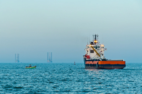 An offshore supply vessel and offshore rigs in the Mediterranean Sea offshore Egypt - Credit: look_67/AdobeStock