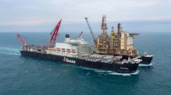 Pioneering Spirit with a decommissioned topsides (left) - Credit: Allseas