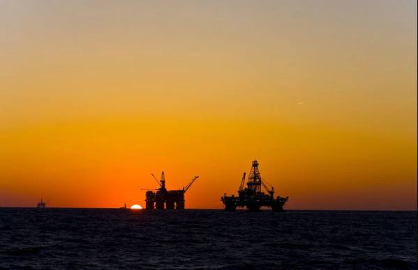 Oil platform silhouette in gulf of mexico - Credit: Lukas Z - AdobeStock
