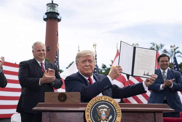 President Donald Trump displays his signature after signing a presidential order extending the moratorium on offshore drilling on Florida’s Gulf and Atlantic Coast, and also the coasts of Georgia and South Carolina Tuesday, September 8, 2020. (Official White House photo by Joyce N. Boghosian)