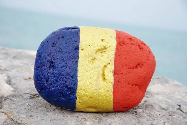 The Romanian flag colors on a stone - Image by  yournameonstones - AdobeStock
