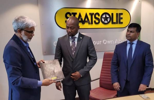 Staatsolie's CEO Annand Jagesar hands over a copy of the contract to Minister of Natural Resources David Abiamofo. On the right Chevron's Suriname Country Manager Channa Kurukulasuriya.  - Credit: Staatsolie