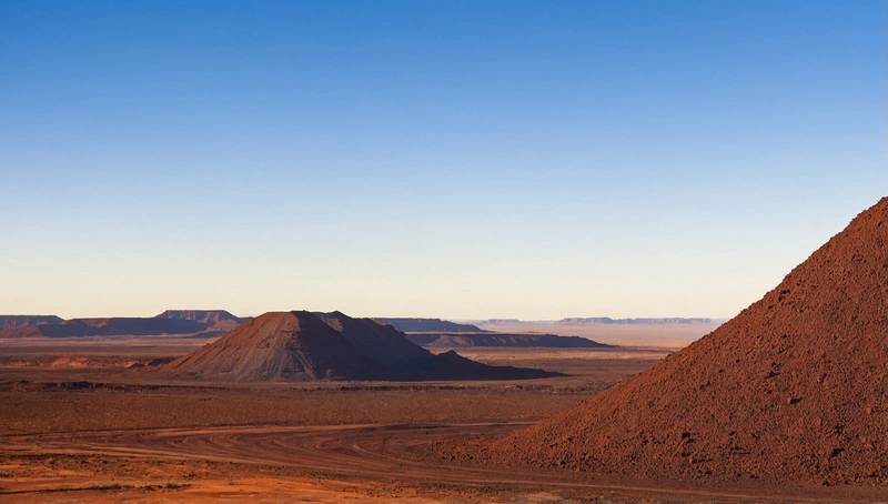 BHP's first-half profit falls by 23% due to lower iron ore price