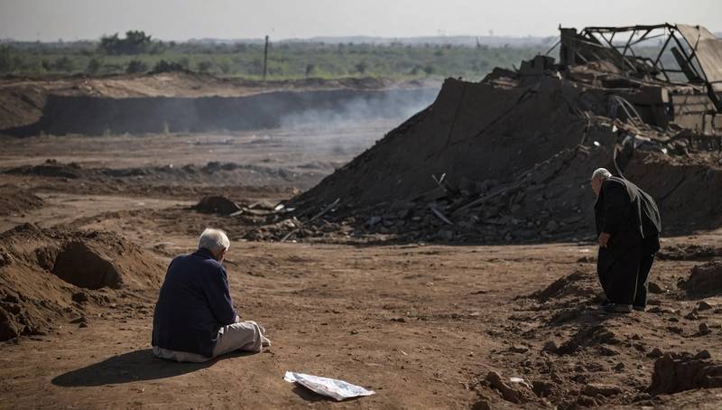 Pensioner waiting at missile attack site for bodies of presumed dead family members