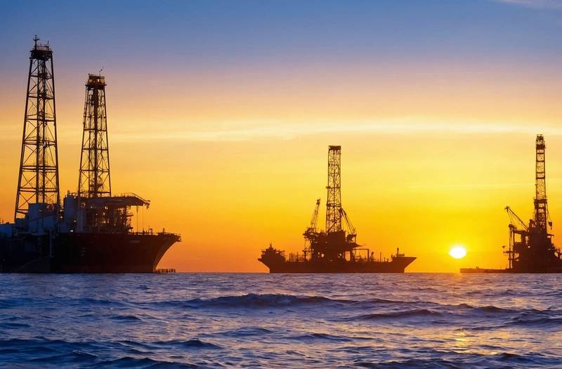 Oil prices drop on forecasts of demand, but global stocks gain